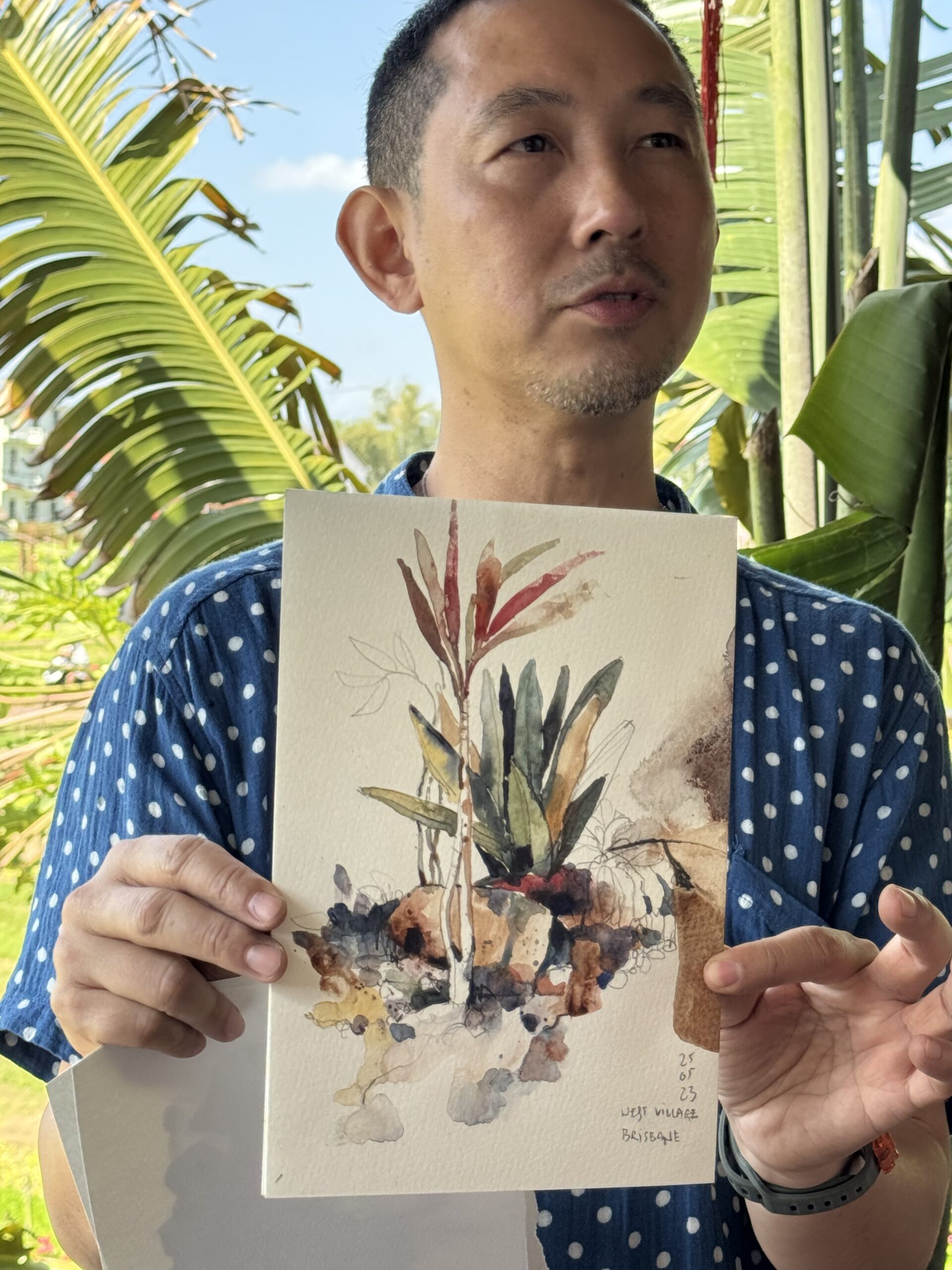 Paul Wang showing a painting